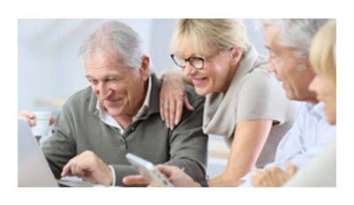 family smiling around a laptop